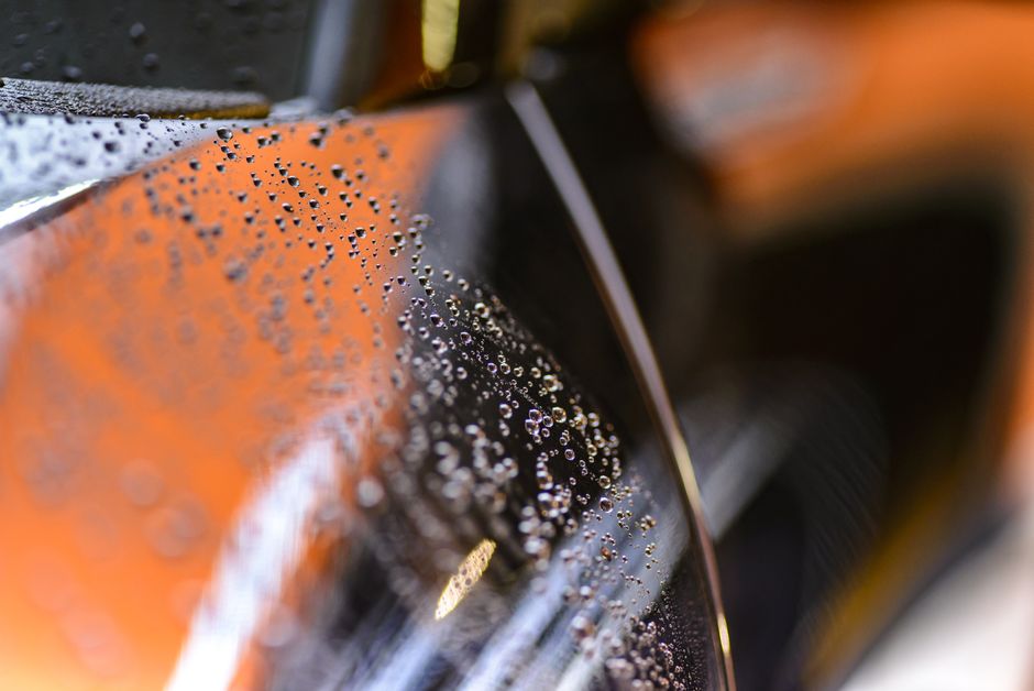 Water beading on car paint demonstrating ceramic coating
